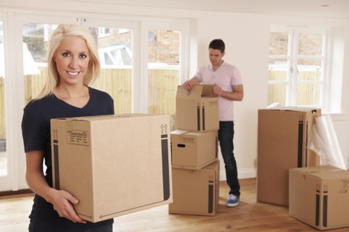 Removalists carrying household items through a Westminster apartment building