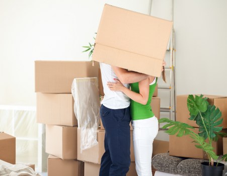Professional movers handling furniture and protective packing in Westminster