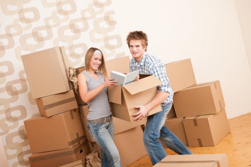 Boxes and furniture being carried through a Westminster residential building