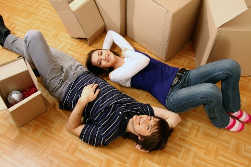 Professional movers carrying boxes and furniture during a flat removal in Westminster